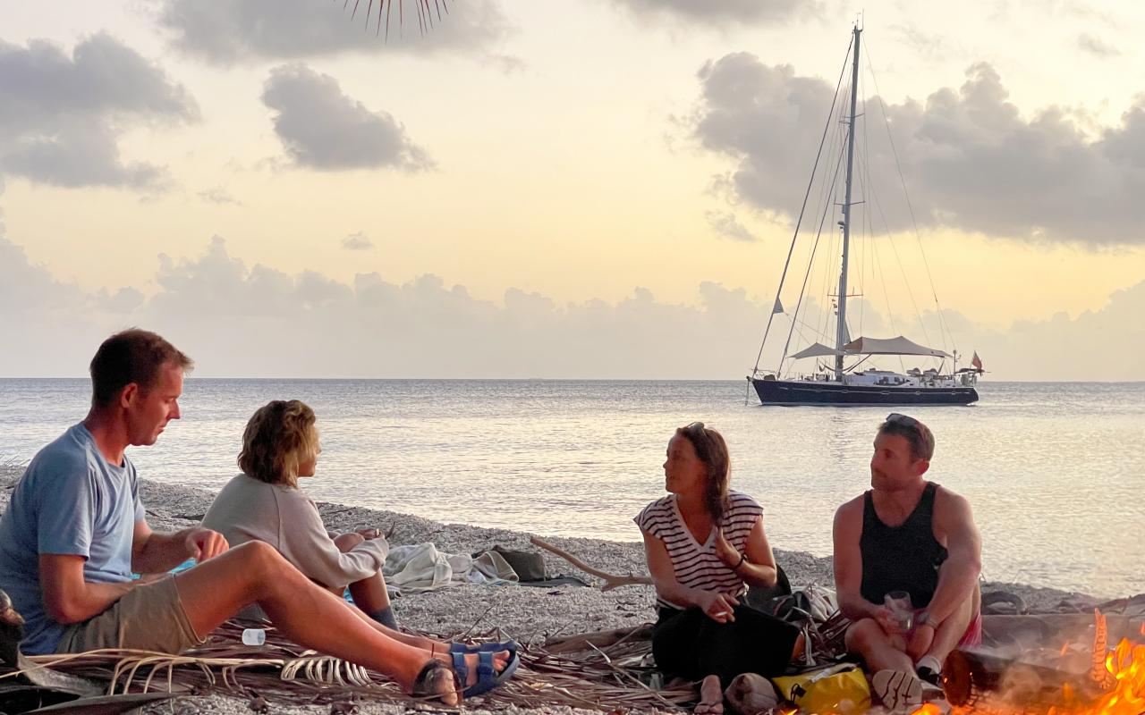 Bonfire on the beach with Uhuru Yacht on the backgorund