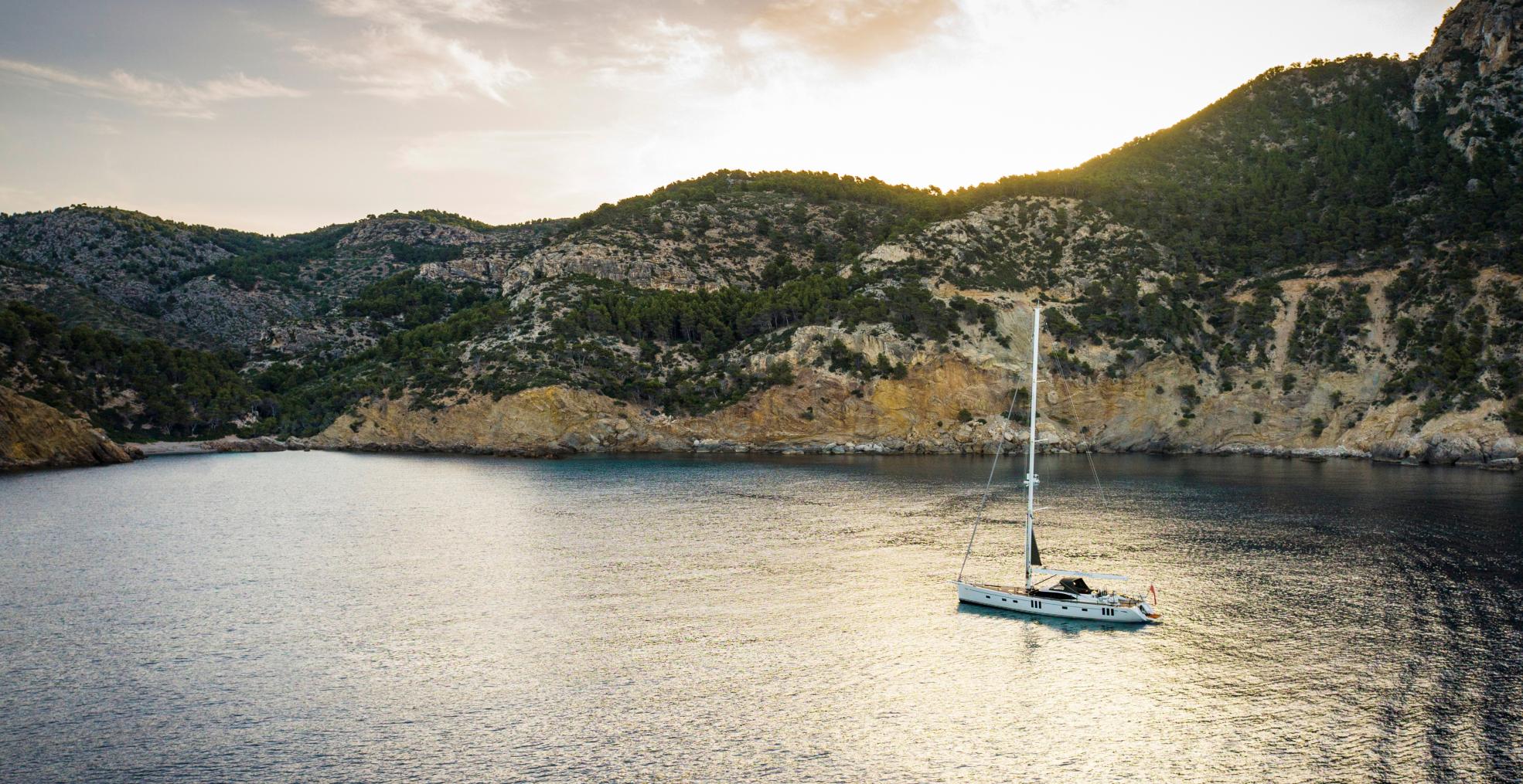 70 foot sailing yacht at anchor mountains 1
