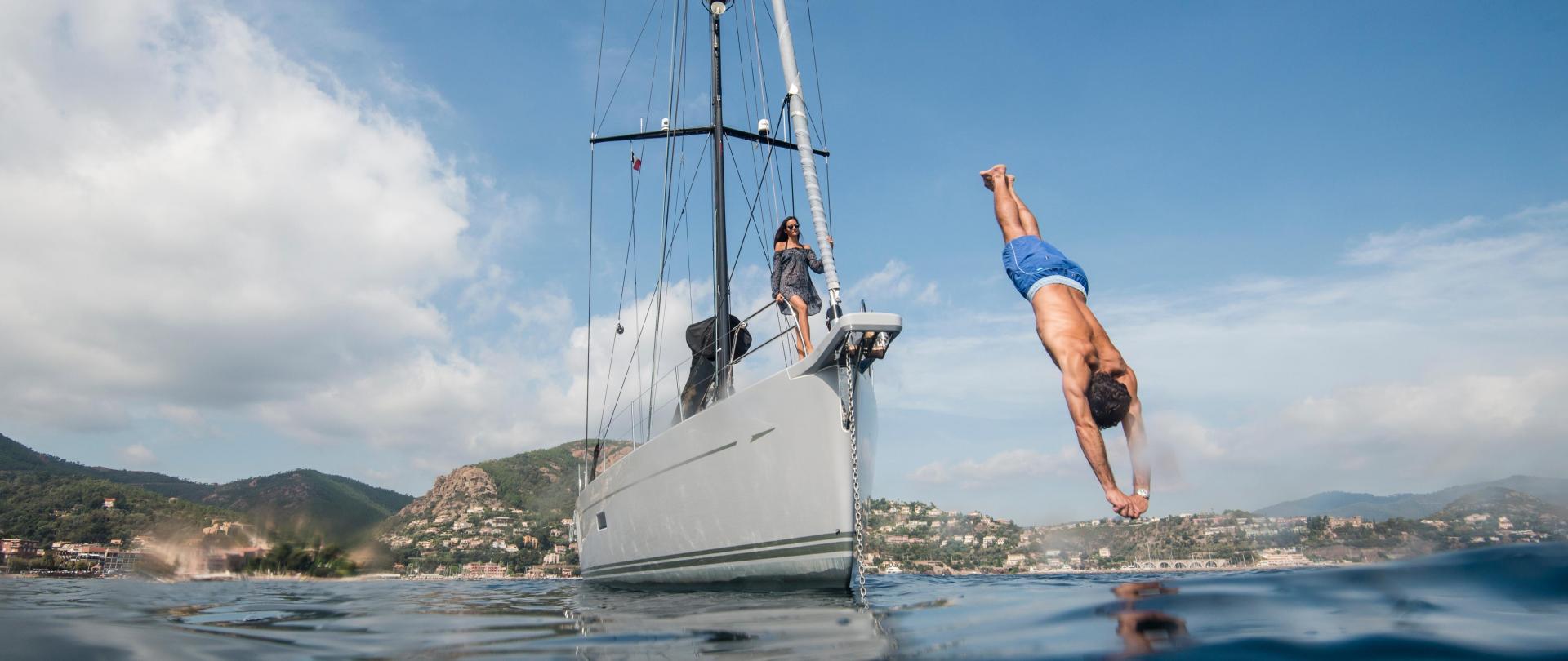 Man diving from an Oyster Charter yacht v2