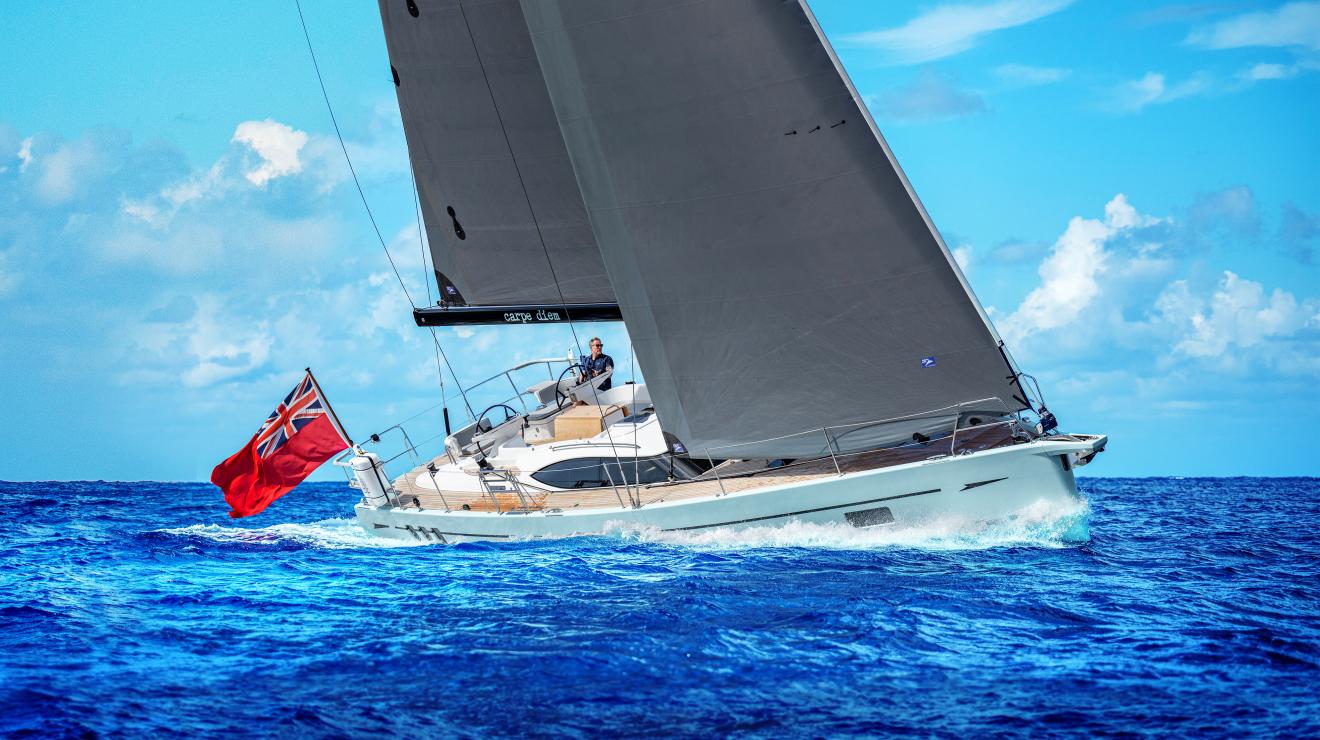 Oyster 495 sailing yacht with man at helm