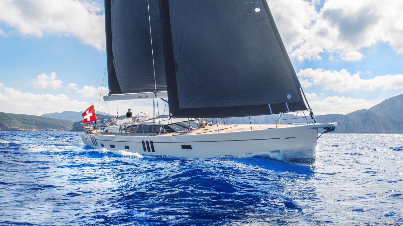Oyster 745 sailing yacht at sea with mountains 1 v2