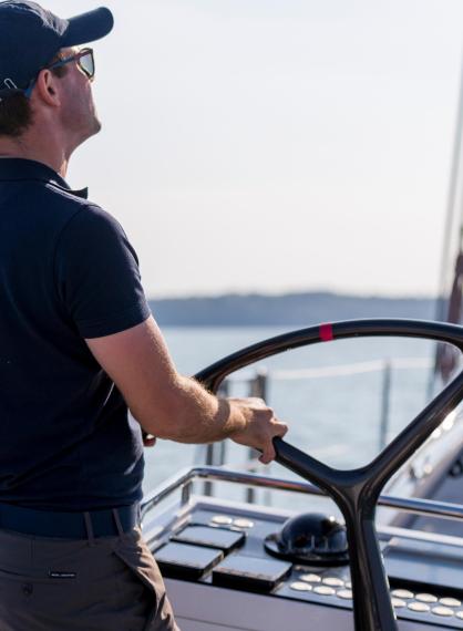 Oyster Yachts Services Crew Man Helming Sailing Yacht
