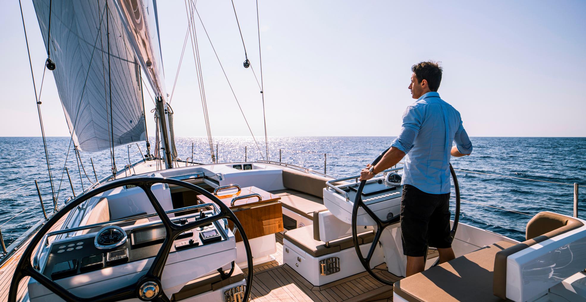 man at helm of 70 foot sailing yacht 2