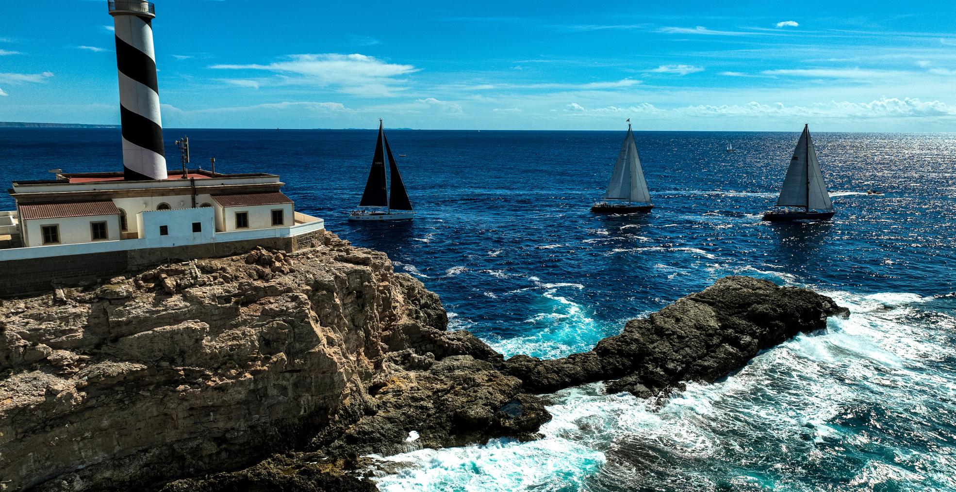 sailing past lighthouse spain