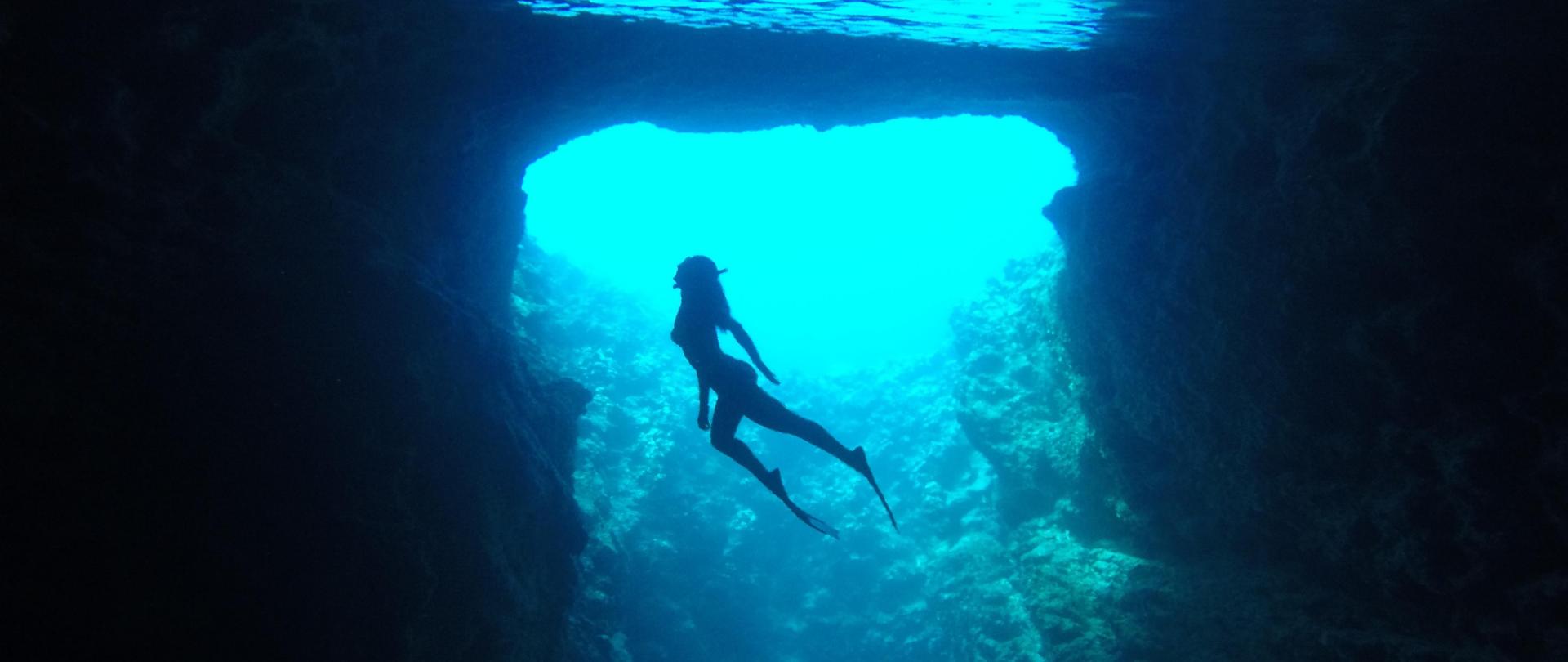 women swimming with scuba gear underwater in crystal clear waters d v2