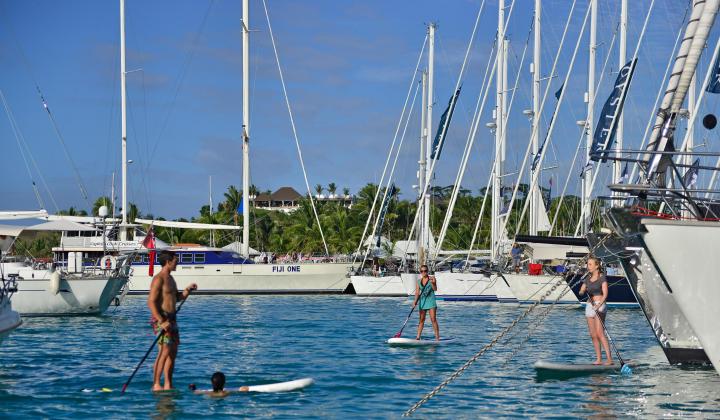 67. Paddle boarding around luxury sailing yachts 