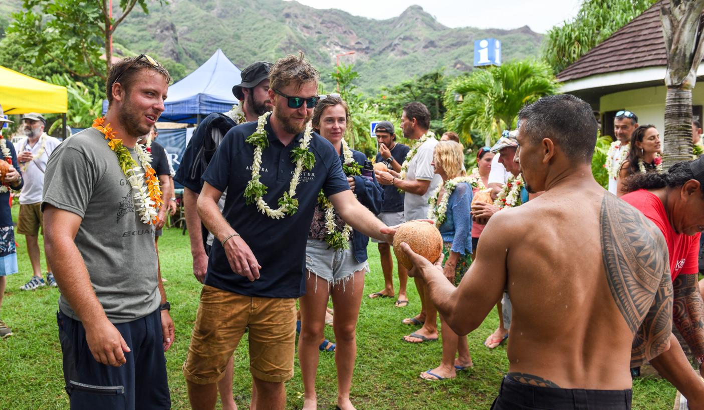 Enjoying fresh coconuts from locals Nuku Hiva