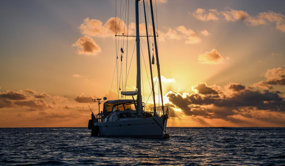 Oyster 655 Jolie at anchor sunset in Tuamotus French Polynesia