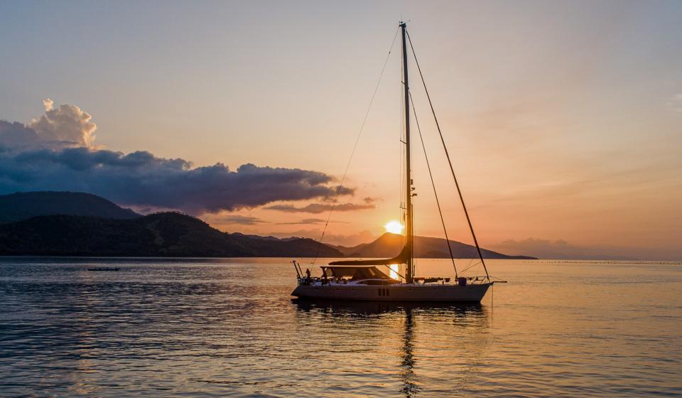 Oyster yacht at anchor sunset Fiji