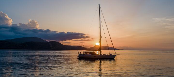 Oyster yacht at anchor sunset Fiji
