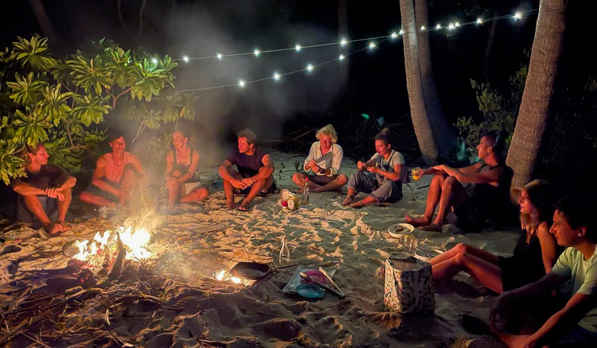 People enjoying bonfire on beach French Polynesia