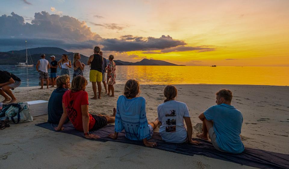 People relaxing on beach sunset Fiji
