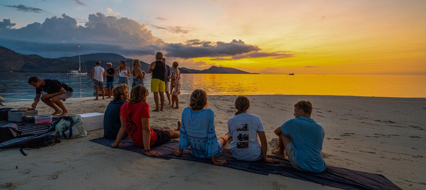 People relaxing on beach sunset Fiji