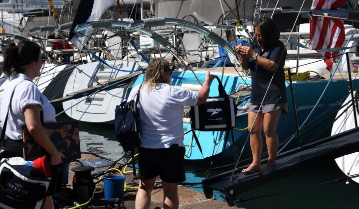 Rally team handing out Dolphins bag to 575 Aurora