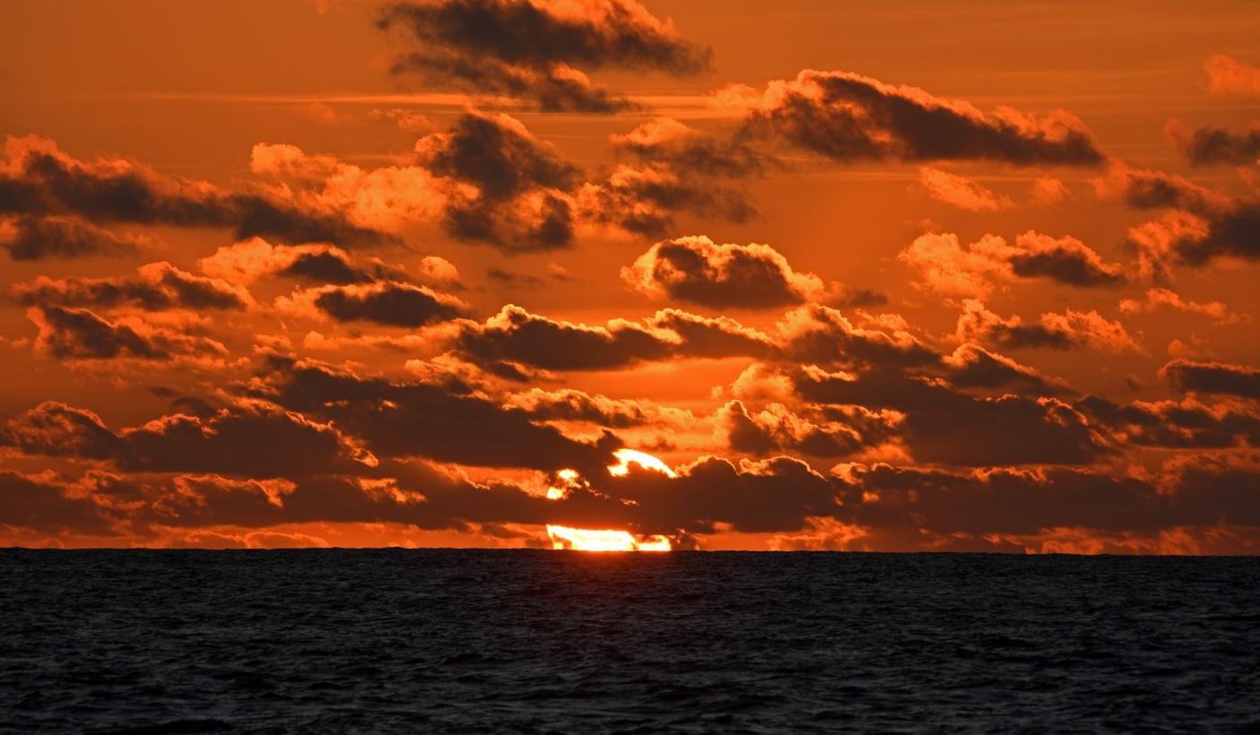 Red cloudy sunset over Pacific Ocean