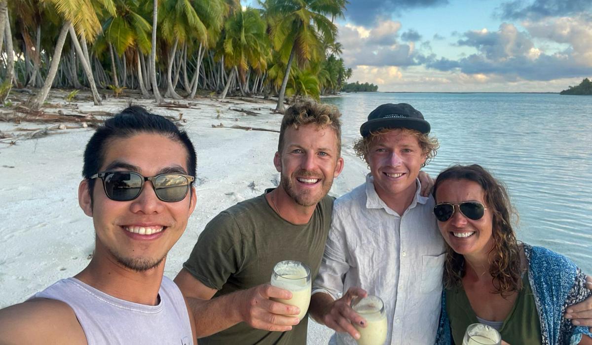 Uhuru crew enjoying drinks on beach French Polynesia
