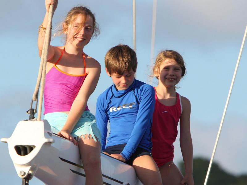 Three children on sailing boats boom