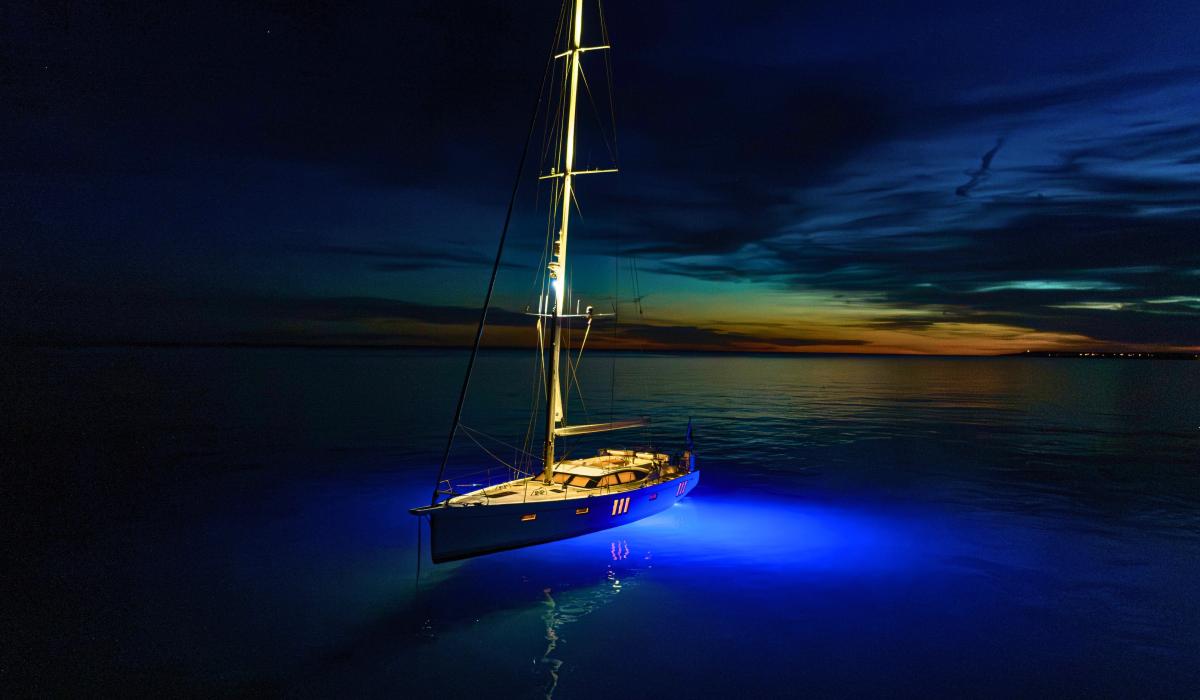  Oyster 595 Series II 60 foot sailing yacht anchored at sea in the night
