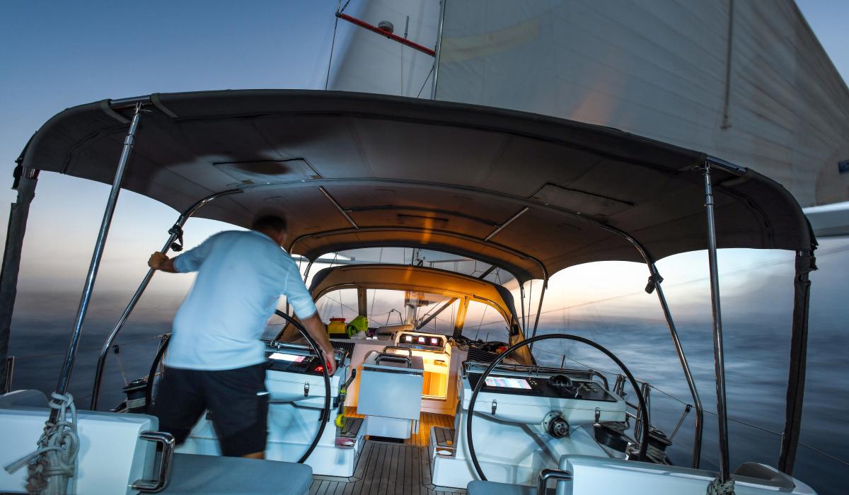 man at helm station on oyster sailing yacht