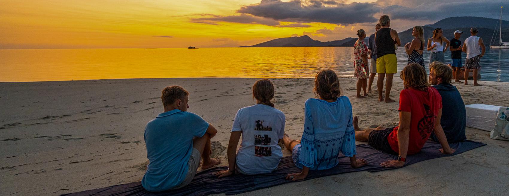 Oyster World Rally Fiji People Relaxing on beach Sunset v2